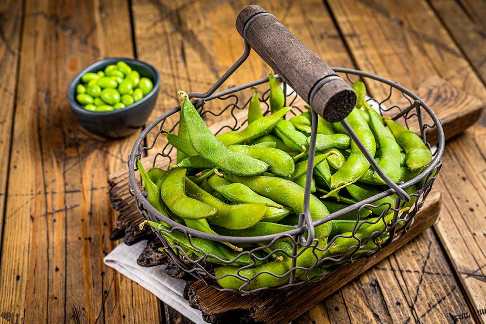 Edamame green Beans, fresh soy beans. Wooden background. Top view